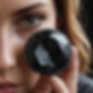 Professional evaluator examining a black diamond under natural light