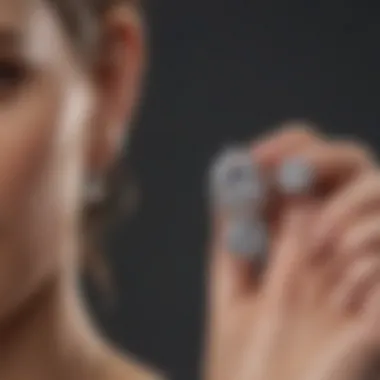 A person using a gentle solution to clean diamond earrings