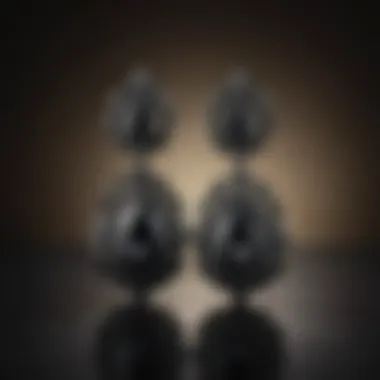 A collection of black diamond earrings displayed on a luxurious velvet background